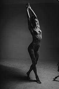 grayscale photography of woman wearing brassiere and panty while stretching thumbnail
