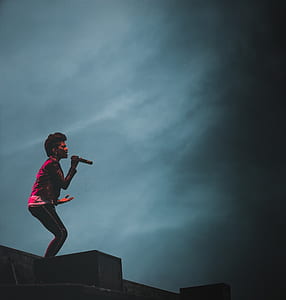 woman singing on stage during concert thumbnail
