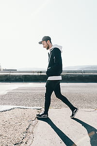 Man Walking on Road Under the Sun thumbnail