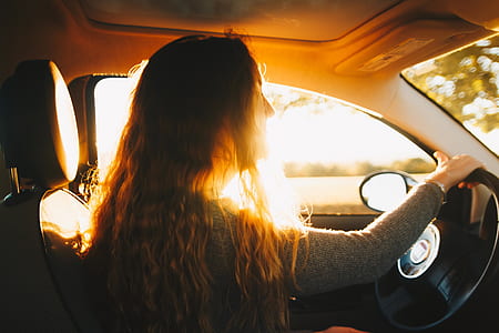 woman wearing long-sleeved shirt driving car thumbnail