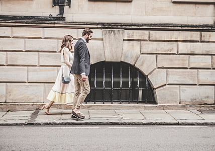man and woman walking on sidewalk thumbnail