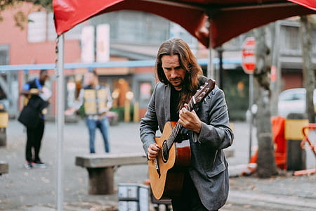 woman playing guitar on street thumbnail