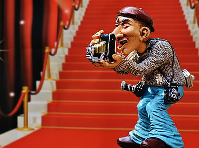photographer figurine standing near staircase thumbnail