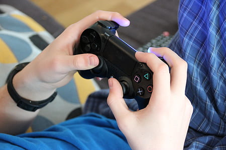 person holding Sony PS4 dual shock thumbnail