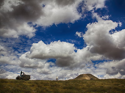 parked gray off-road vehicle under sunny sky thumbnail