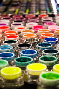 stack of assorted-color opened paint bottles thumbnail