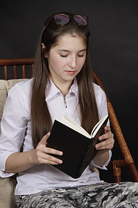 woman wearing pink collared elbow-sleeved shirt reading book thumbnail
