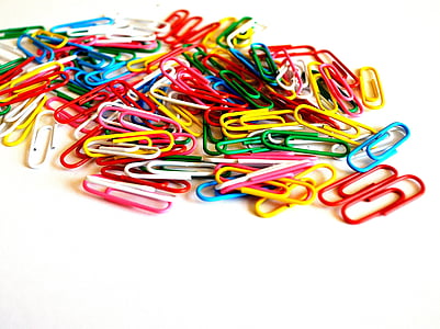 assorted-color paper clip lot on table thumbnail