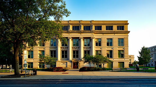 photo of brown and beige concrete painted building during daytime thumbnail