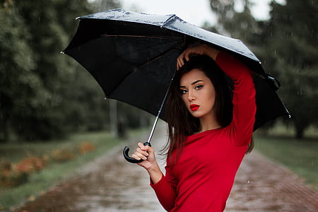 shallow focus photography of woman wearing red long-sleeved shirt thumbnail