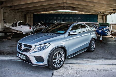 blue Mercedes-Benz sedan parked on garage thumbnail