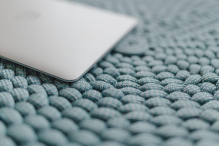 MacBook Laptop on a blue pouf thumbnail