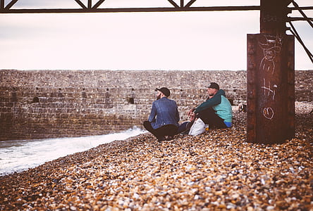 two men sitting near canal thumbnail