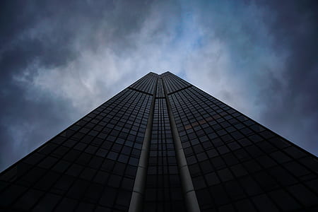low-angle photography of high-rise building under cloudy sky thumbnail