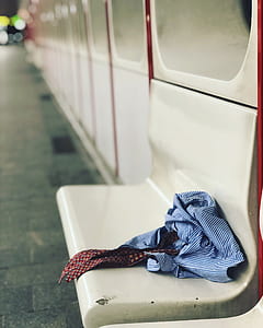 blue and white pinstriped shirt with red necktie on bench thumbnail