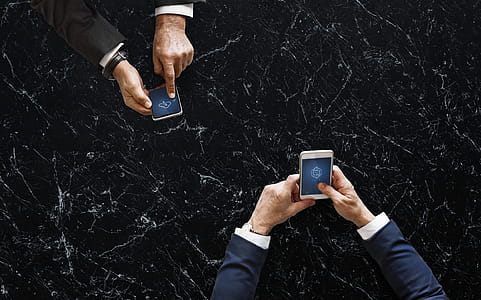 Two Person Holding White and Black Android Smartphones thumbnail
