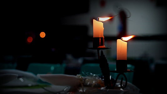 two brown lighted candles thumbnail