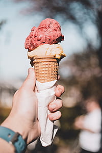 person holding ice cream in cone thumbnail