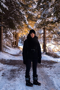 woman in middle of snow covered road thumbnail
