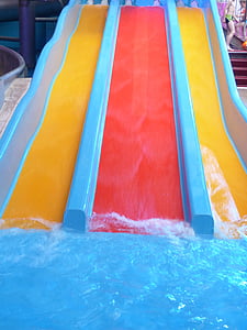photo of red and yellow concrete slide towards swimming pool thumbnail