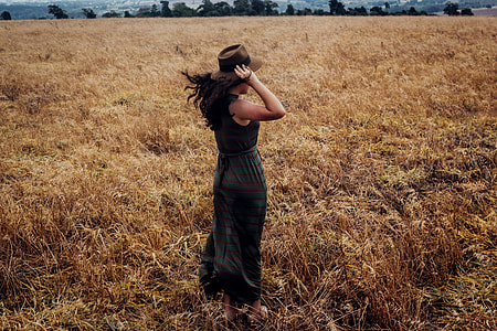 Woman wearing a hat standing in a wheat field thumbnail