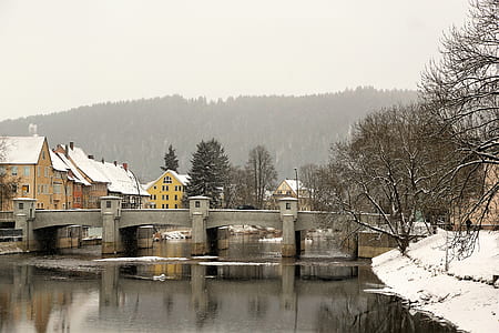 gray concrete bridge near houses during daytime thumbnail