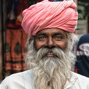 focused photo of man wearing red turban and shirt thumbnail