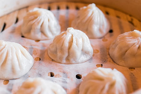 dumplings on brown wooden steamer thumbnail