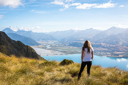 woman on top of cliff with grasses thumbnail