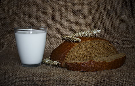 milk filled glass beside sliced bread thumbnail