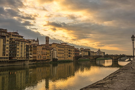 reflection photography of houses and bridge during golden hour thumbnail