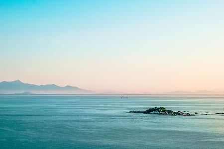 Body of Water Under Clear Blue Sky during Daytime thumbnail