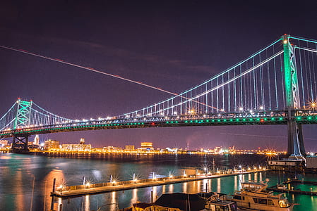 green lighted bridge above body of water thumbnail