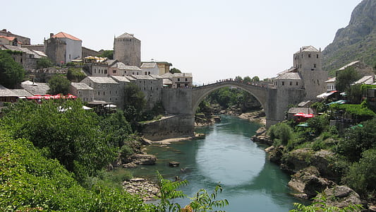 photo of gray concrete bridge across river thumbnail