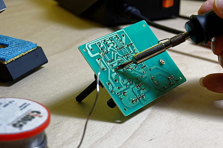 person holding black soldering rod thumbnail