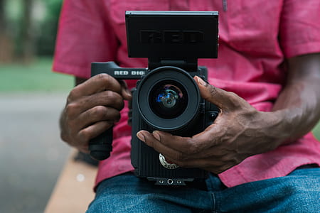 person holding black DSLR camera thumbnail