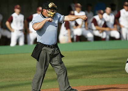 coach standing on middle of basebal lfield thumbnail