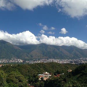 village near mountain under blue sky thumbnail