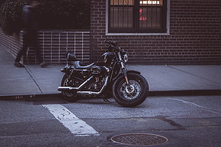 black cruiser motorcycle parked near sidewalk thumbnail