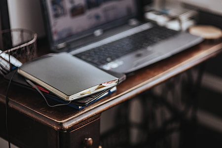 Workplace with a laptop and a notebook on a desk thumbnail