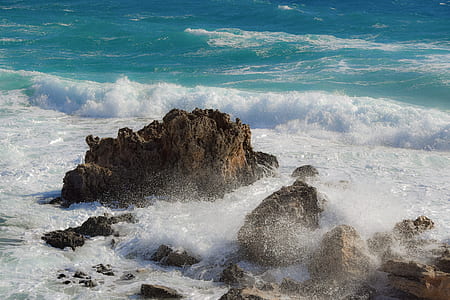 brown rock formation near sea thumbnail
