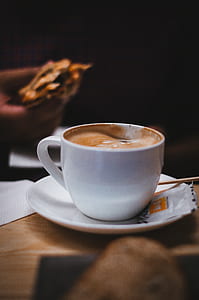white coffee cup on white saucer on brown board thumbnail