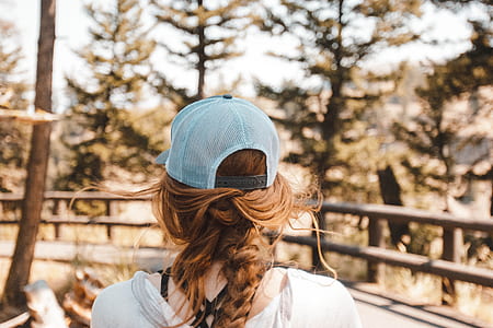 shallow focus photo of person wearing trucker hat thumbnail