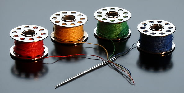 red, yellow, green, and blue treads beside silver needle thumbnail