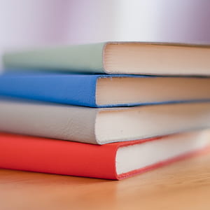 four books stacked together in macro shot thumbnail