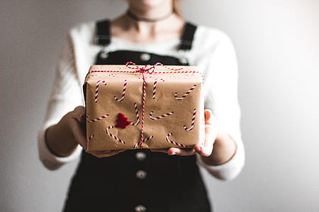 person holding brown gift box thumbnail