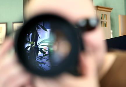 person holding black camera thumbnail