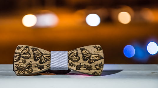 selective focus photography of beige and brown butterfly-printed bow thumbnail