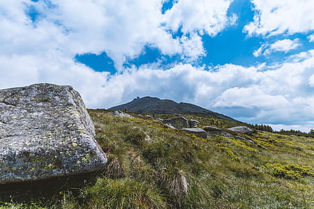 View of a mountain with a large stone in the foreground thumbnail