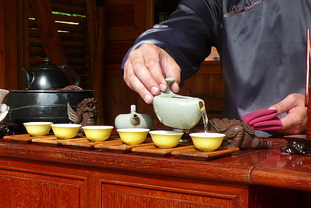 six round yellow ceramic bowls and two grey teapots thumbnail